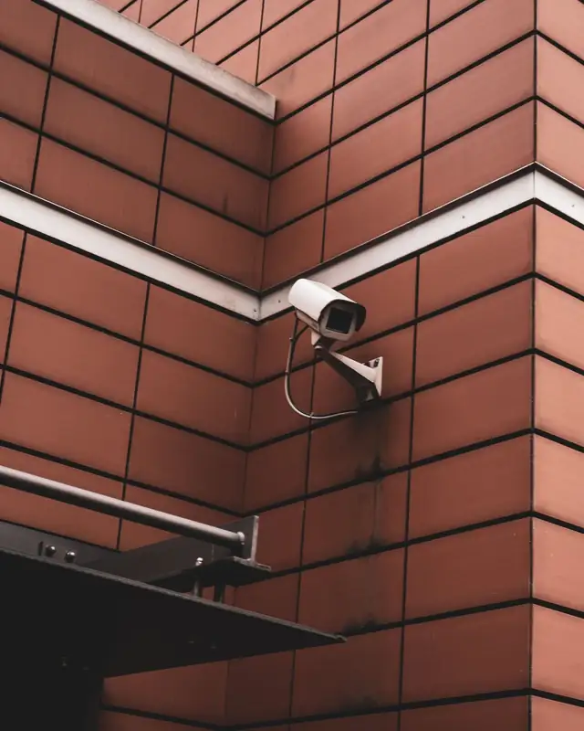 An existing CCTV camera on a wall, watching the entrance